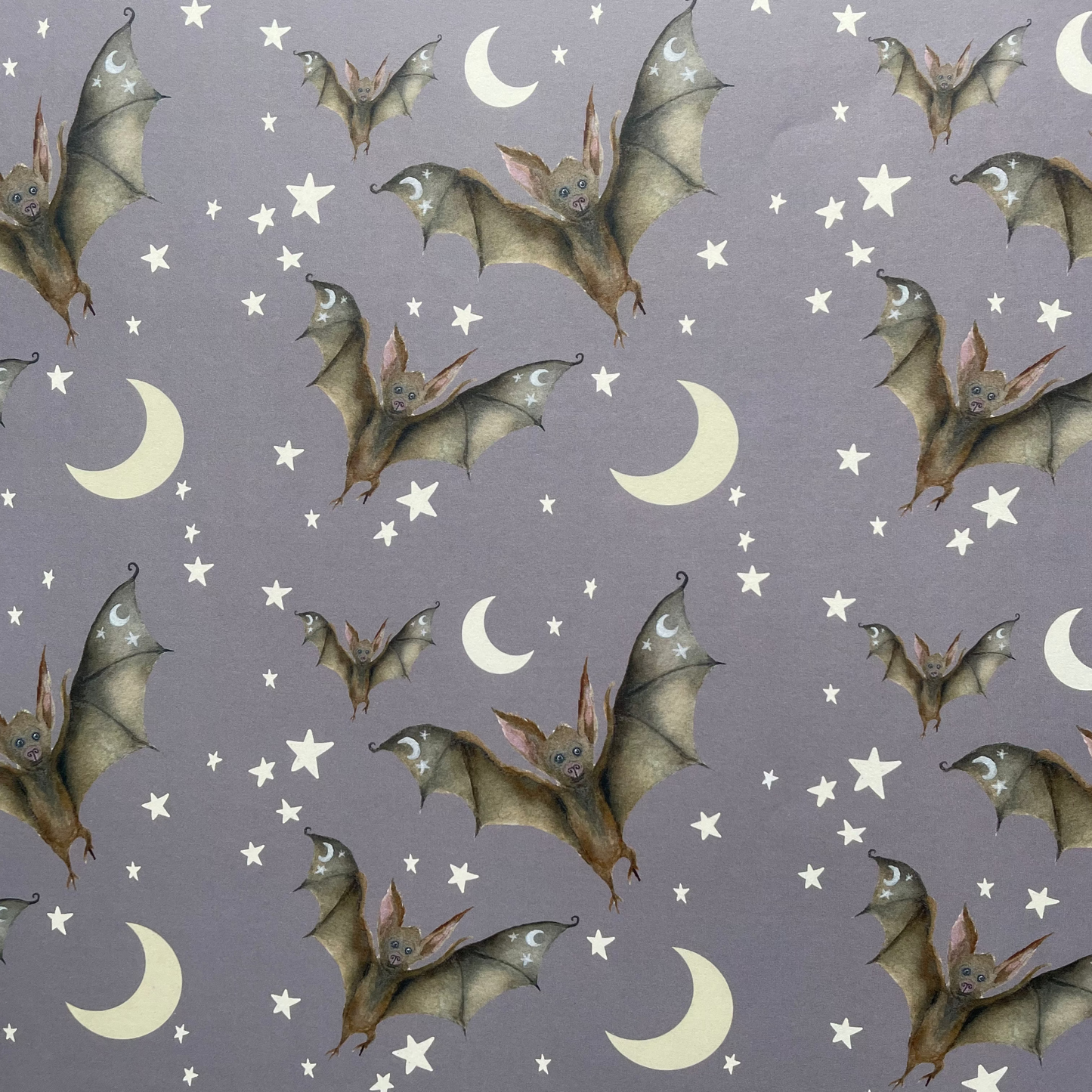 Pattern of bats and moon shapes on a gray background