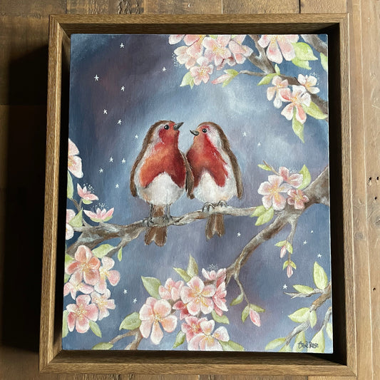 Framed artwork of two birds on a branch with cherry blossoms against a night sky.