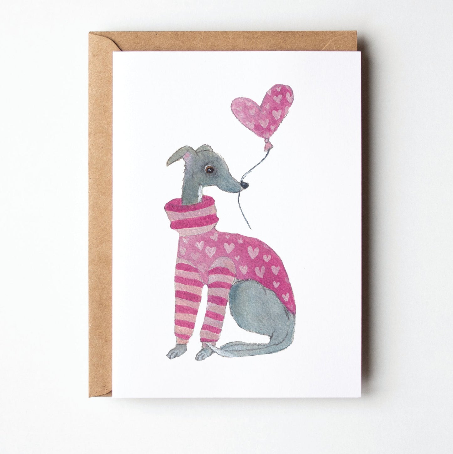 Card with a cute illustration of a dog in a striped sweater holding a heart-shaped balloon, on a white background.