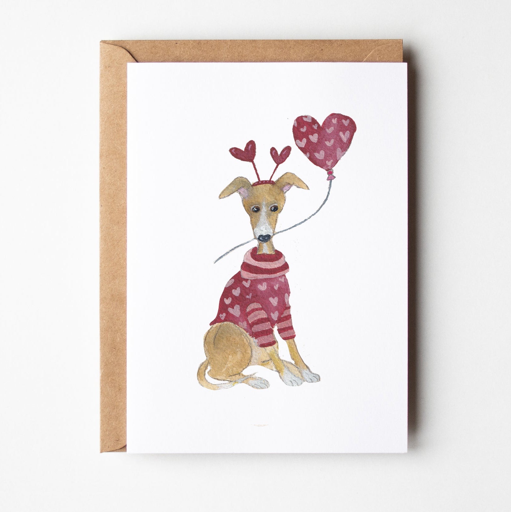Illustration of a dog in a sweater holding a heart-shaped balloon on a white background with a brown border.