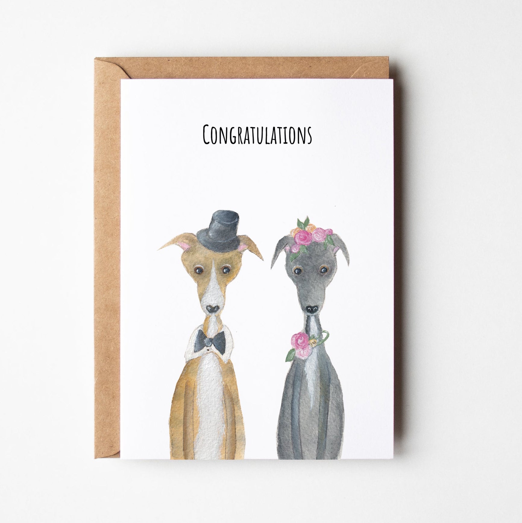 Greeting card with two dogs wearing wedding attire and 'Congratulations' text on a white background.