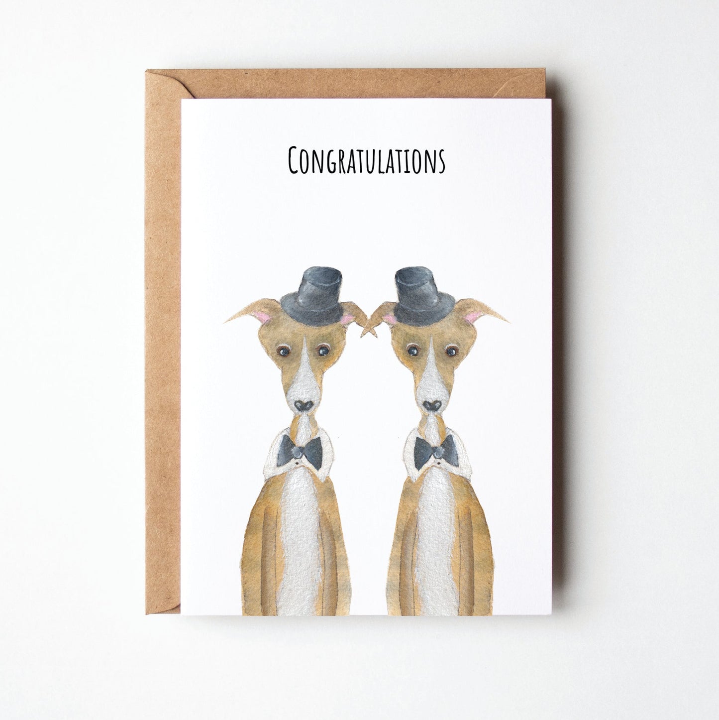 Greeting card with two dogs wearing top hats and the text 'Congratulations' on a white background.