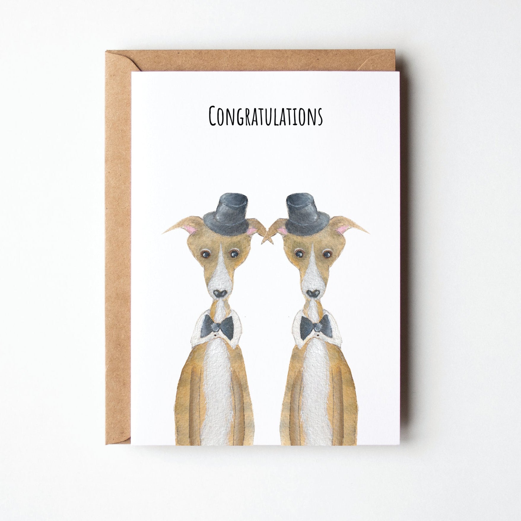 Greeting card with two dogs wearing top hats and the text 'Congratulations' on a white background.