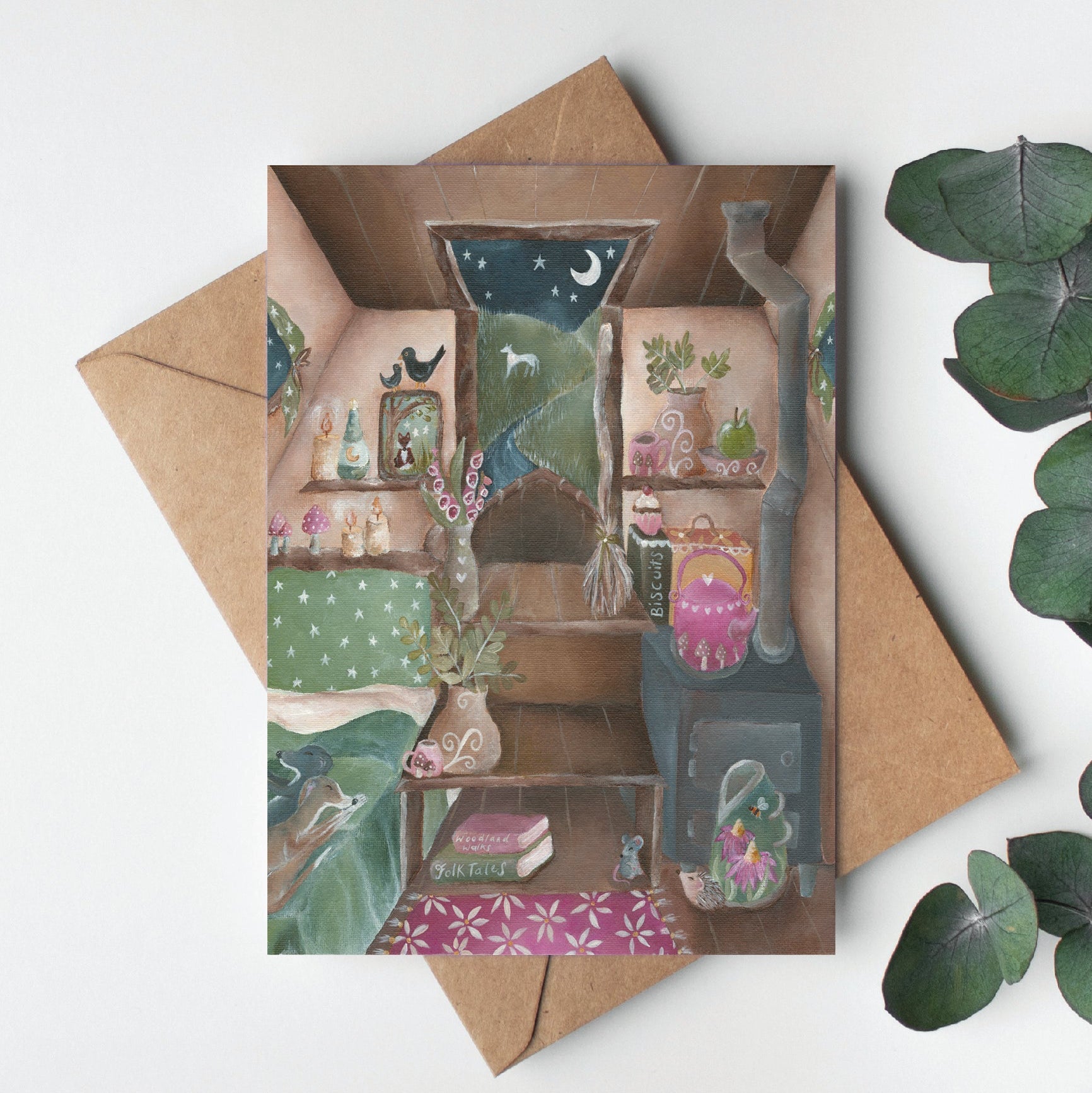 Greeting card with a miniature landscape design, surrounded by green leaves on a light background