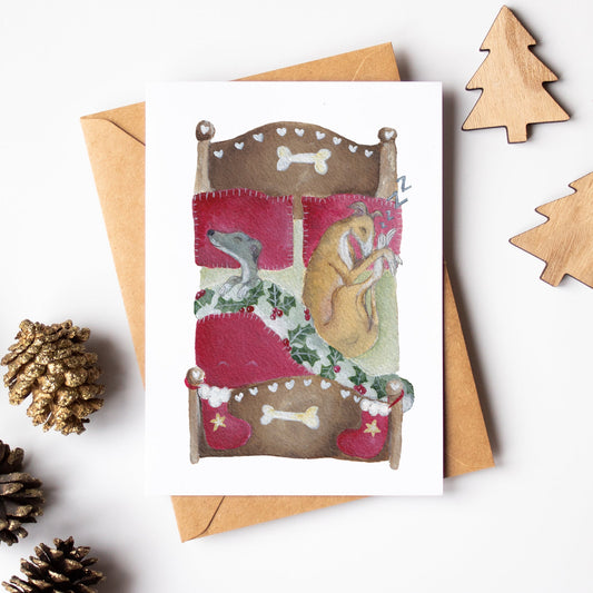Christmas card with a dog and cat illustration, surrounded by pine cones and wooden trees on a white background.